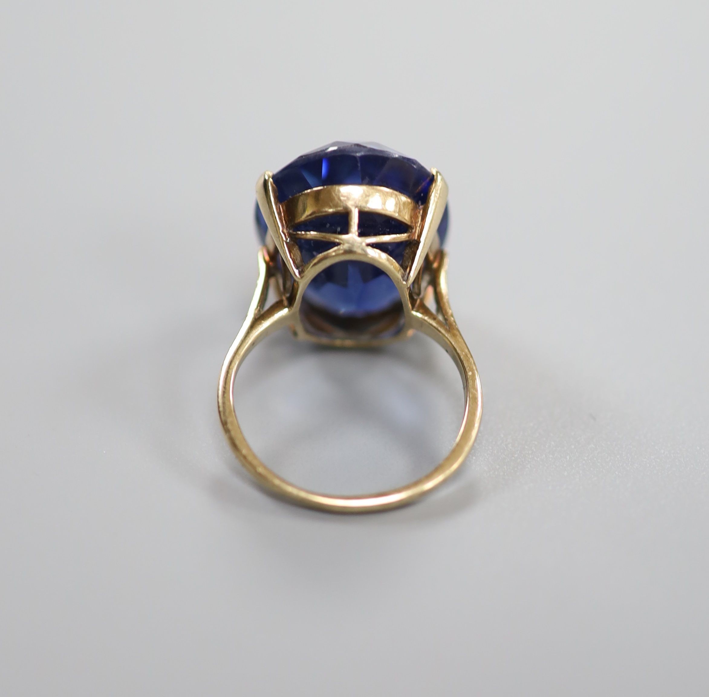 A 9ct gold and oval cut synthetic sapphire set dress ring, size L/M, gross 7.6 grams.